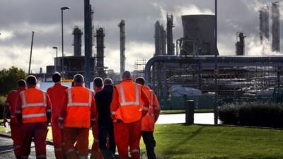 Workers walk through the Grangemouth complex