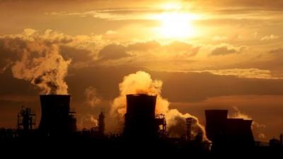 In this file picture taken on April 27, 2008 the sun sets behind the Grangemouth Oil Refinery in Grangemouth, central Scotland.