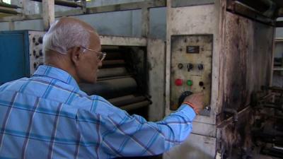 Man shows destroyed printing press