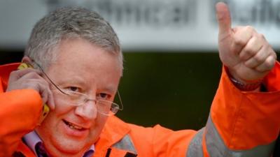 A worker gives a thumbs up after learning the Grangemouth plant will stay open