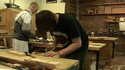 Adults taking wood work lessons