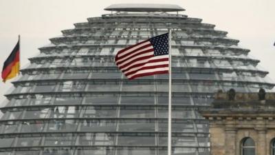 US flag flying over embassy next to German Parliament