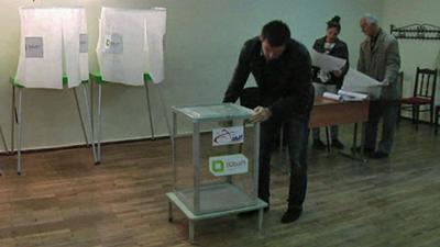 Election helpers setting up ballot boxes