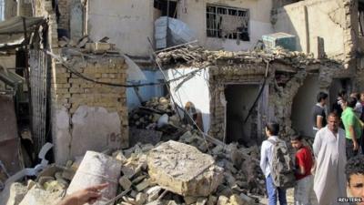 Two boys looking at rubble following explosion