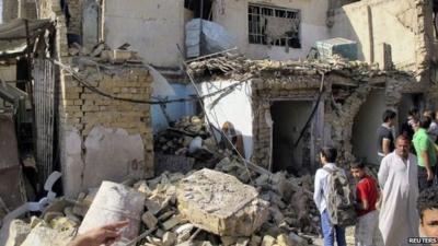 Two boys looking at rubble following explosion