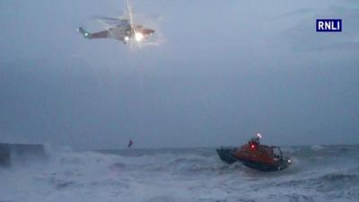 Helicopter and lifeboat in stormy seas