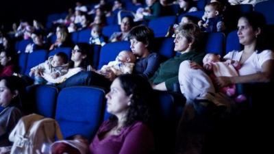 Mothers and their babies at a film screening