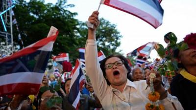 Thai opposition protesters wave national flags