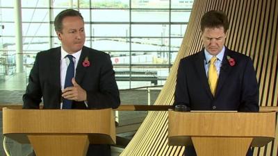 David Cameron and Nick Clegg speaking at the Welsh Parliament