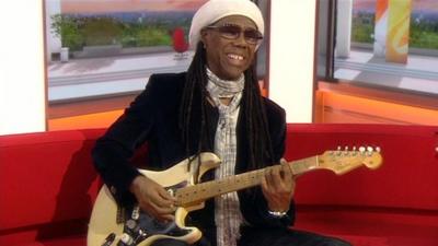 Musician Nile Rodgers performs on the BBC Breakfast sofa