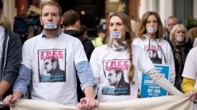 Demonstrators take part in a silent protest outside the Russian embassy in west London on November 2, 2013, in support of Kieron Bryan, a journalist currently being held in a Russian prison