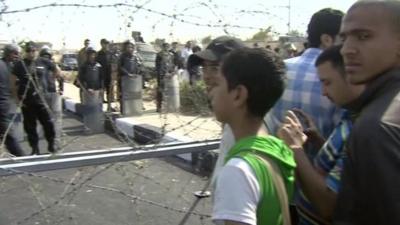 Barbed wire separates the protesters from the security forces