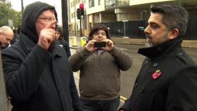 A protester confronts Brent Council's leader