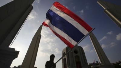 Anti-government protester waves flag in Bangkok