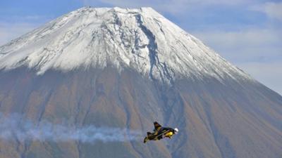 Jetman flying past Mount Fuji