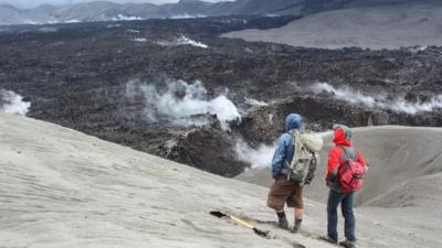 Researchers watch the obsidian flow at Cordon Caulle volcano in Chile