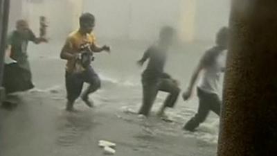 Four people in floodwaters