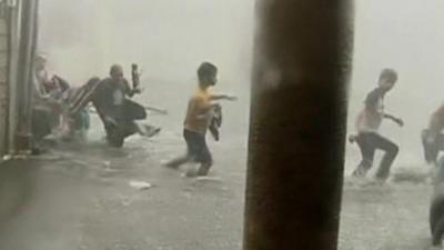 People wading through flooding