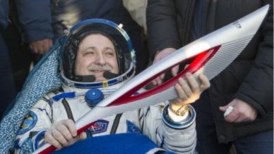 Russian cosmonaut Fyodor Yurchikhin holds the torch of the 2014 Sochi Winter Olympic Games after Soyuz TMA-09M capsule landed in a remote area in central Kazakhstan Monday, Nov. 11, 2013