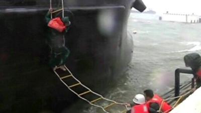 Crew being rescued a storm-stricken Chinese ship