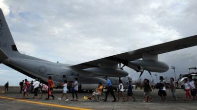 Survivors of Super Typhoon Haiyan board plane