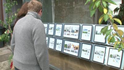 Couple outside estate agent