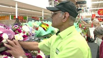 older worker in supermarket