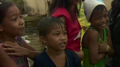 Children queue for rice