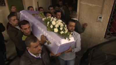 Family members bring out the coffin of a child who was killed after a mortar attack in Damascus