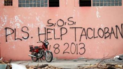 A message seeking help is written on the wall of destroyed building by residents on November 13, 2013 in Tacloban, Leyte, Philippines