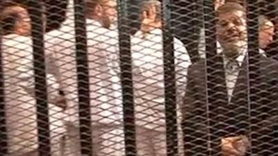 Mohammed Morsi on trial in a Cairo courtroom on 4 November 2013