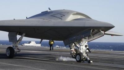 The Navy experimental unmanned aircraft, the X-47B, is launched off the deck of the nuclear powered aircraft carrier USS Theodore Roosevelt off the Virginia coast, Sunday, Nov. 10, 2013