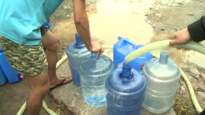 Water cans being filled