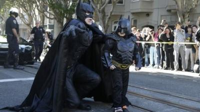 Miles Scott (right), walks with a man dressed as Batman in San Francisco, California, on 15 November 2013