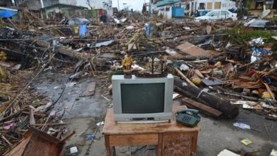 A television set sits on a table on a road amongst debris in Tacloban City on November 14, 2013 in Tacloban, Philippines