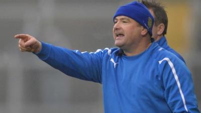 Martin McKinless gives instructions to his Ballinderry team against Kilcoo