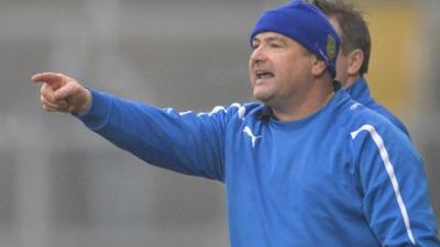 Martin McKinless gives instructions to his Ballinderry team against Kilcoo