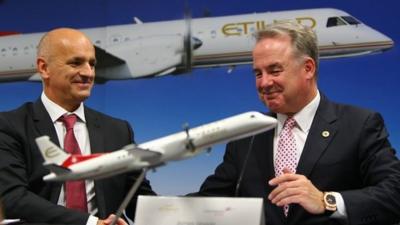 Etihad president James Hogan (R) & Maurizio Merlo of Darwin Airlines shake hands after sealing a deal