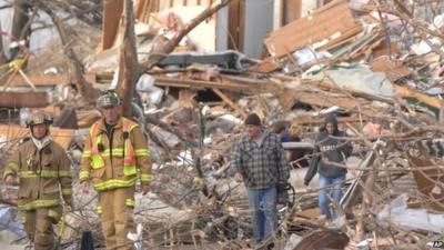 Firefighters survey debris in Devonshire Street , Washington, Illinois