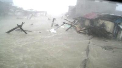 Still from video of house being washed away