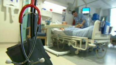 Blood pressure monitoring equipment and nurse checking patient