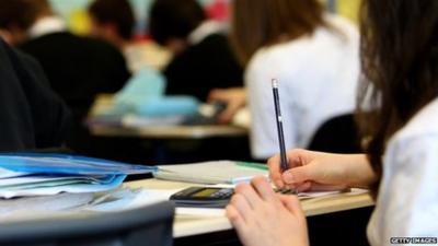 A school girl writing at a desk