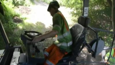 Worker resurfacing road