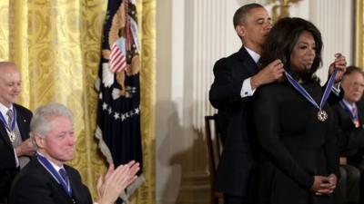 Oprah Winfrey is awarded Medal of Freedom, while Bill Clinton looks on