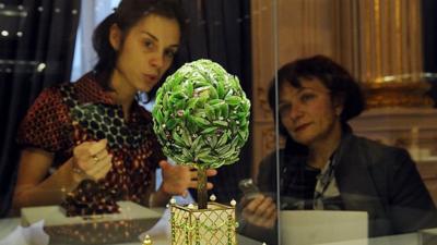 Visitors to Russia's first Faberge Museum observe one item from its vast collection