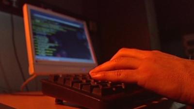 Man typing on keyboard and computer monitor