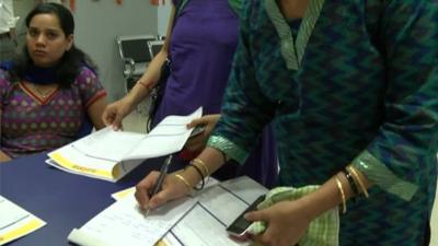 Women filling in bank forms