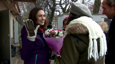 Alex Harris of Greenpeace waves as she leaves prison