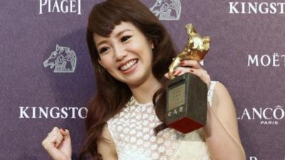 Taiwanese actress and singer Kuo Shu-yau holds Golden Horse award