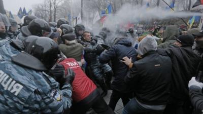 Protesters and riot police clash